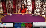 A smaller in-game image of a female Baccarat dealer at the Genesis live casino.