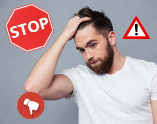 Man looking stressed and confused with warning signs around him