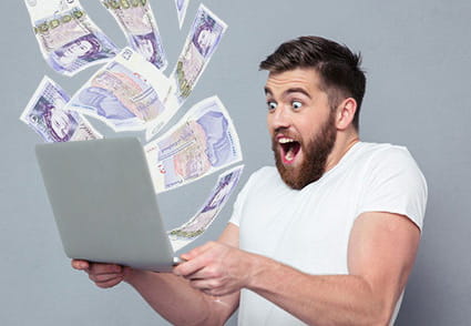 Man winning a massive jackpot on his laptop