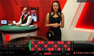 An image of a Ladbrokes live dealer handing out cards for a game of baccarat