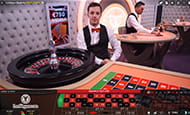 A smaller image of a male croupier wearing an orange bowtie hosts a roulette wheel for the LeoVegas live casino.